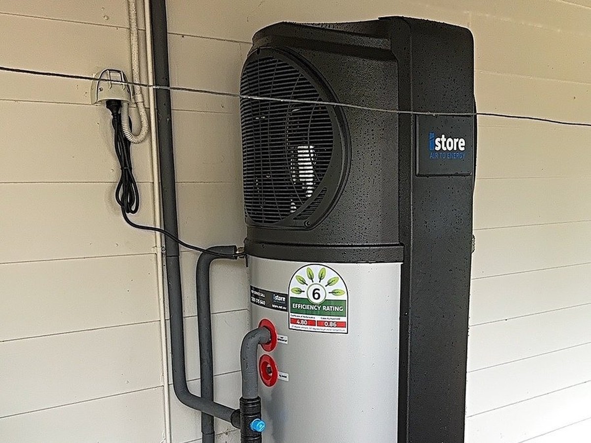 iStore heat pump hot water system installed against a wall