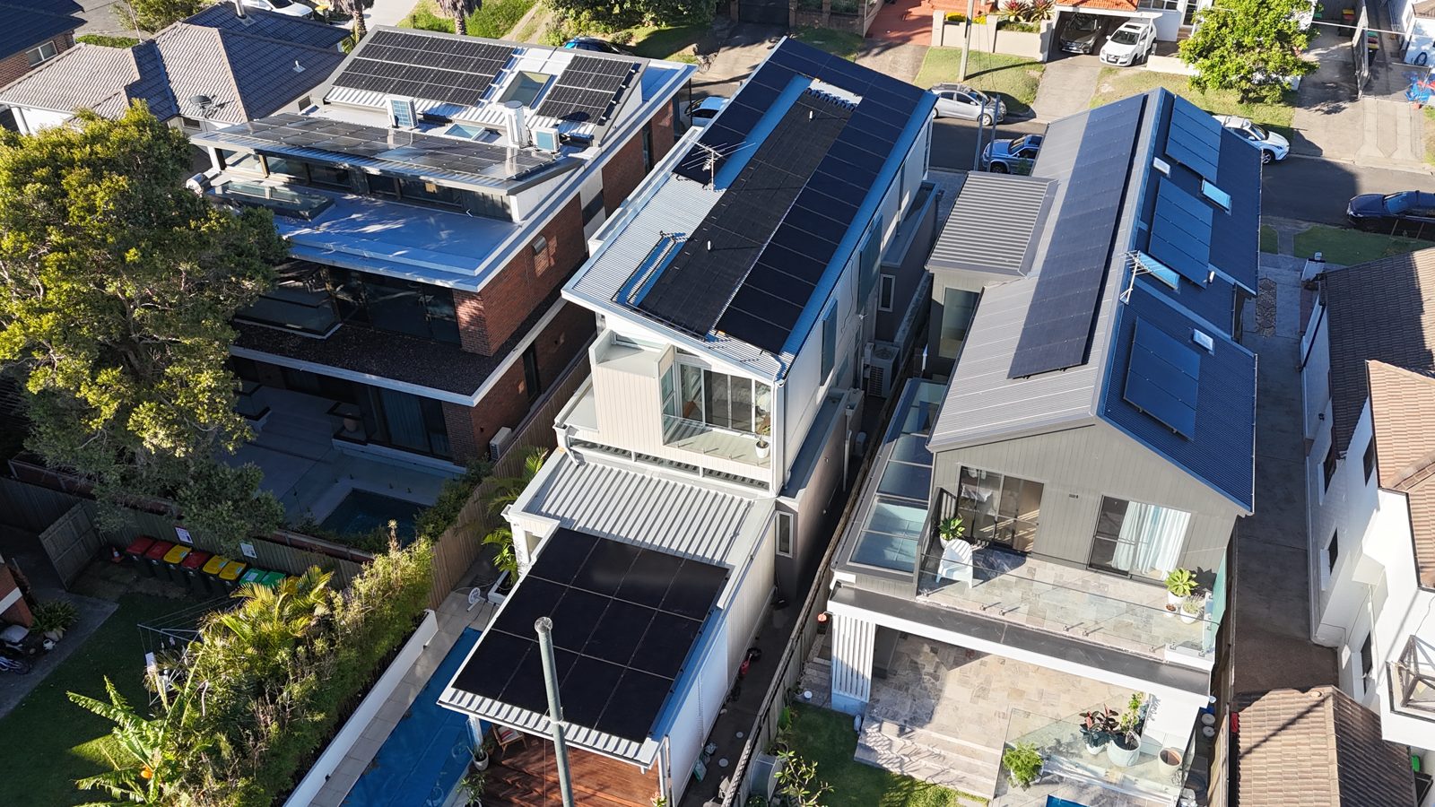 Aerial view of a modern architectural apartment building with solar panels