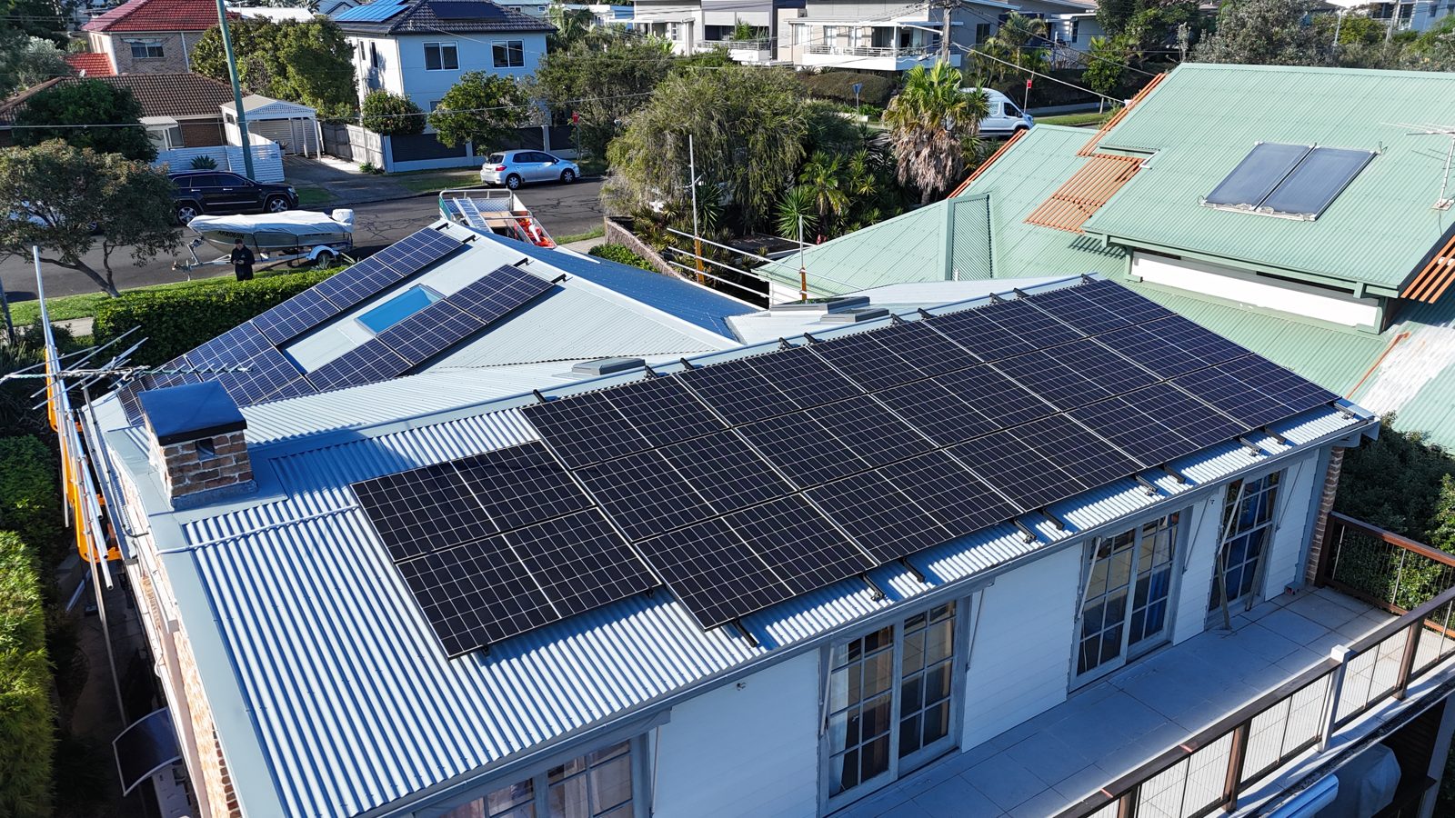 Aerial view of a large uniform solar panel array on a long skillion roof