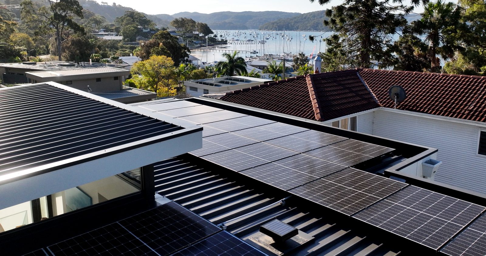 Rooftop solar install with a harbour view in the background