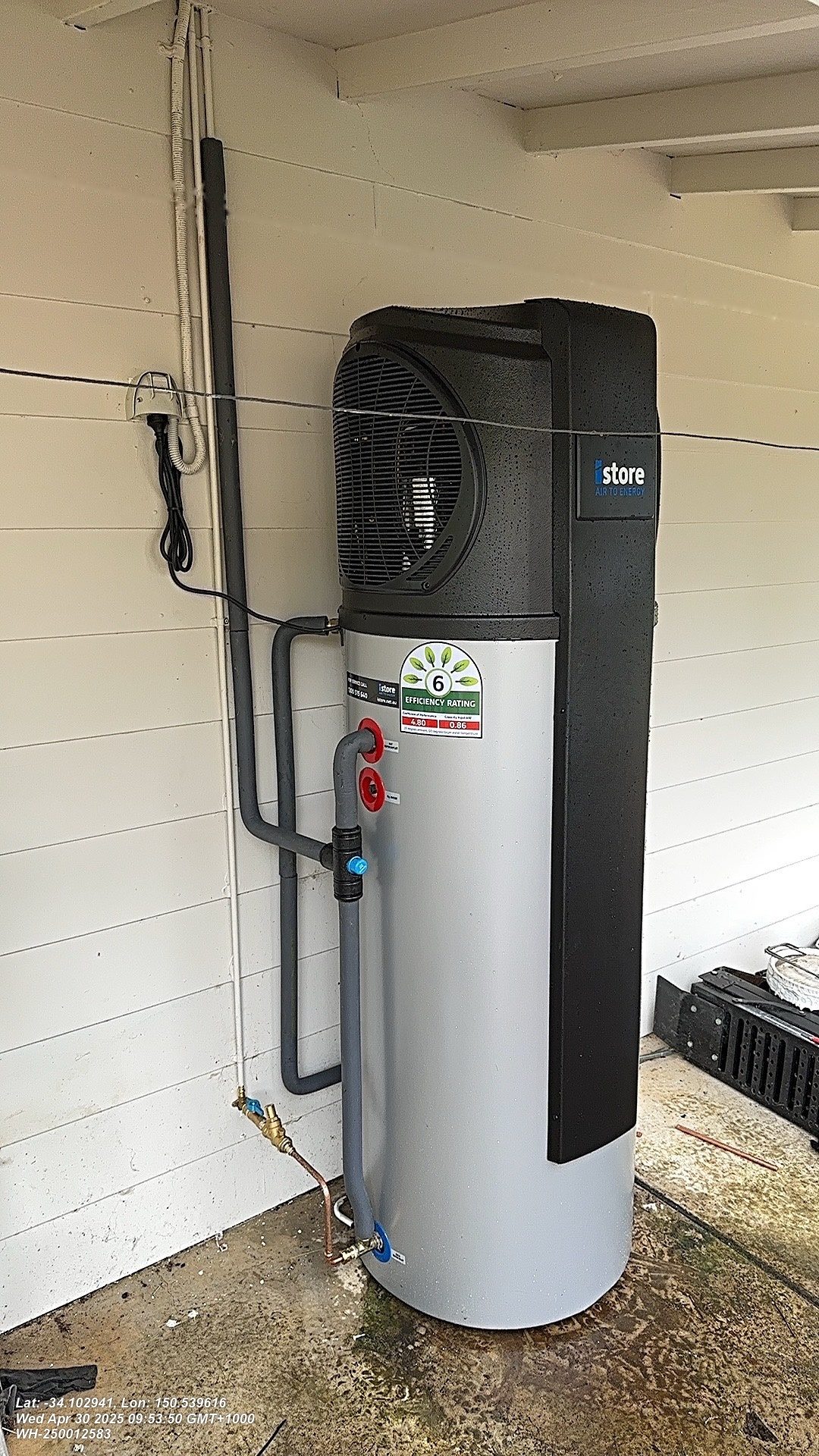 iStore heat pump hot water unit installed on a wall
