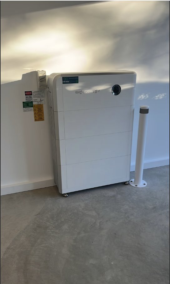 Sigenergy home battery installed in a garage, branded with an Infinite Electrical & Solar sticker